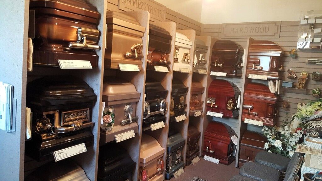 A room filled with lots of coffins and flowers