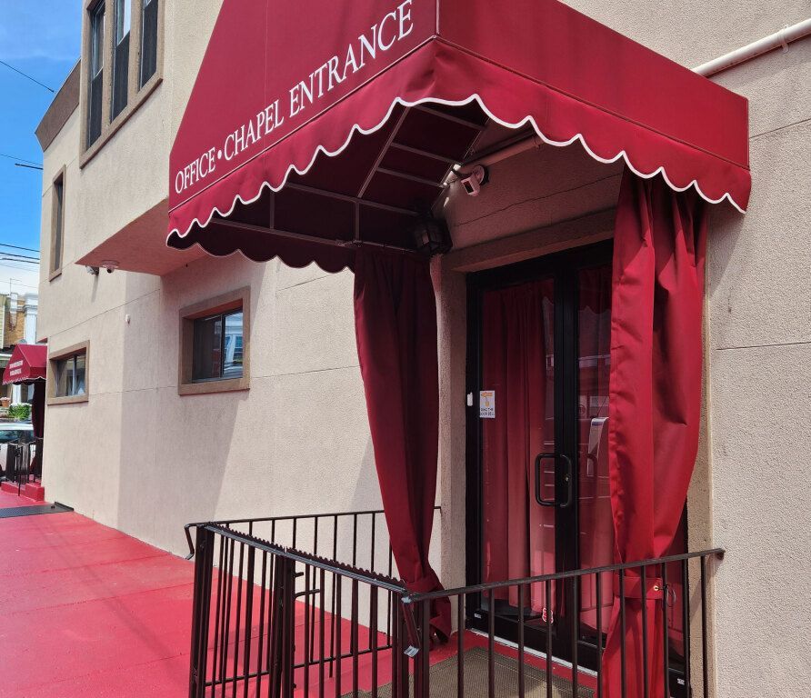 A building with a red awning that says office-chapel entrance