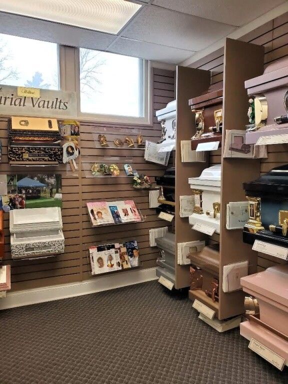 There are many different types of coffins on display in this room.