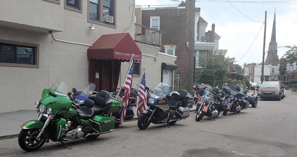 A row of motorcycles parked in front of a building