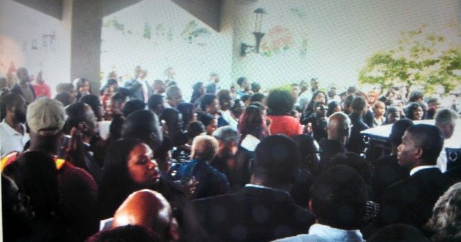 A large group of people are gathered in a room