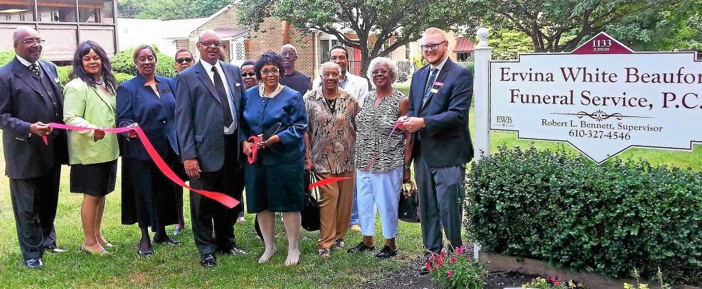 A group of people standing in front of a sign that says loving white heather