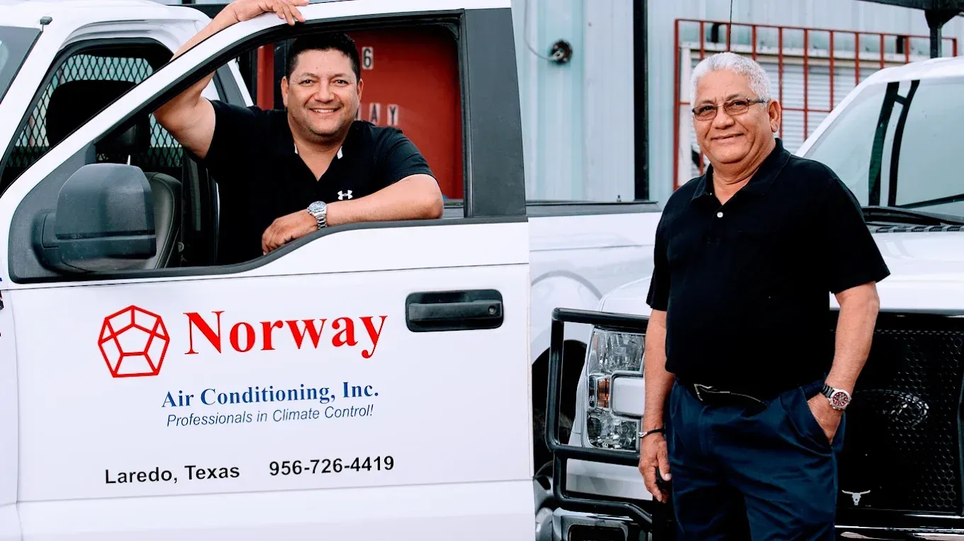 Two men by a white truck with 