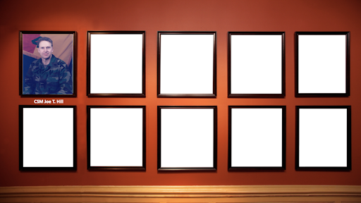 A picture of a man in a military uniform is surrounded by empty frames on a wall.