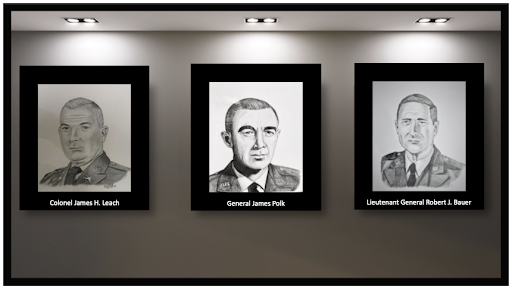 Three black and white portraits of men are hanging on a wall