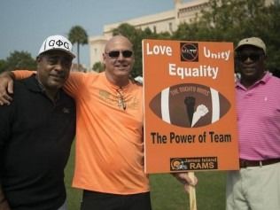 Three men hold a sign with the words