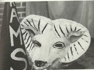 Ram mascot head with striped horns and 