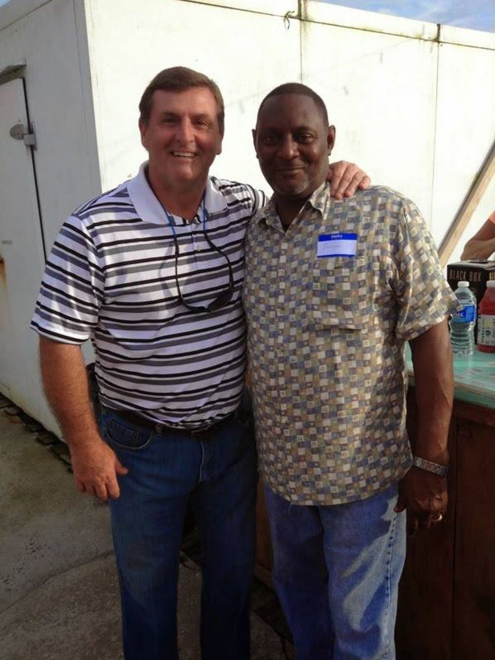 Two men pose together.