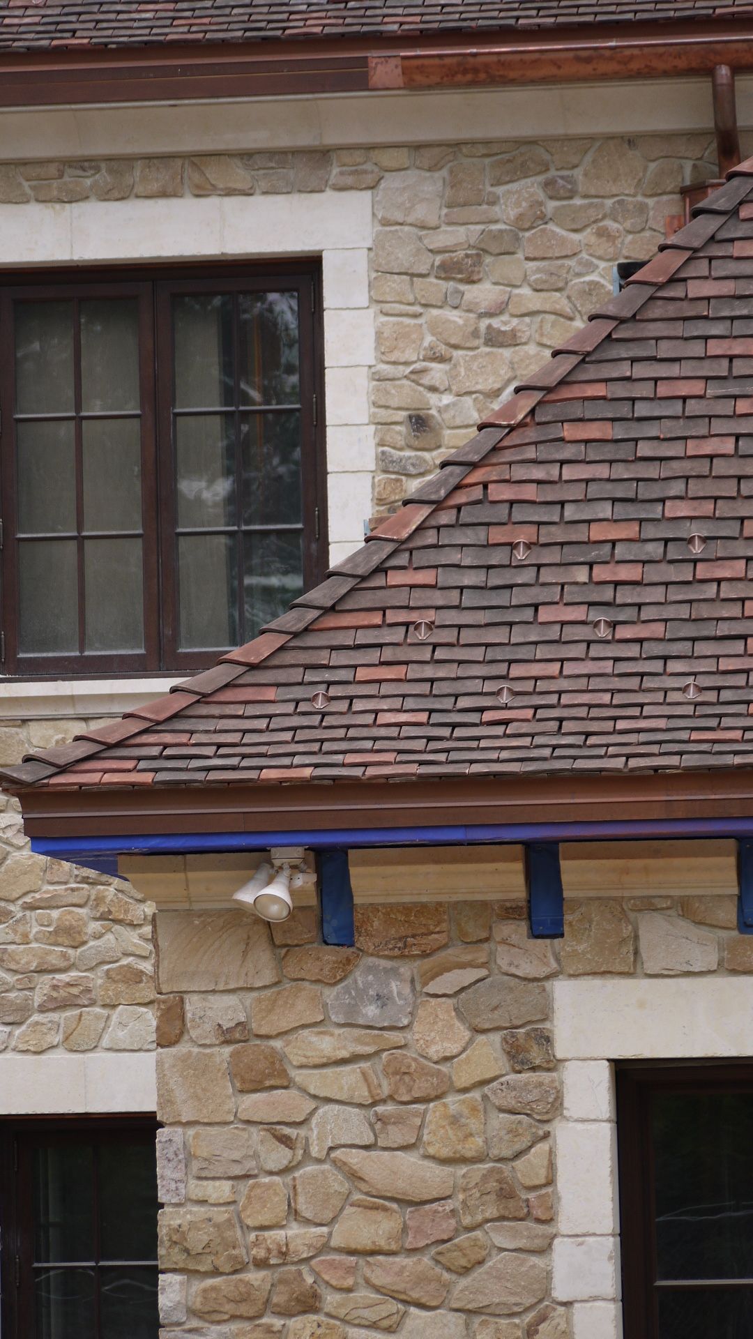 Elegant clay tiles installed on a home by Kudu Roofing.