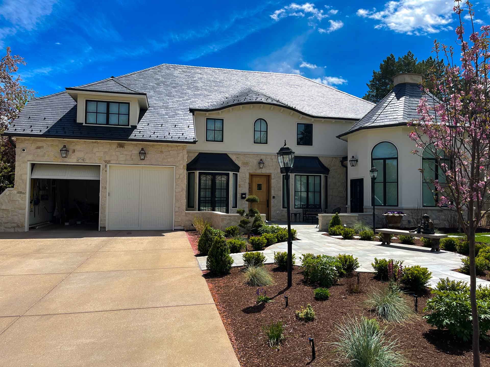 A large white house with a garage and a driveway