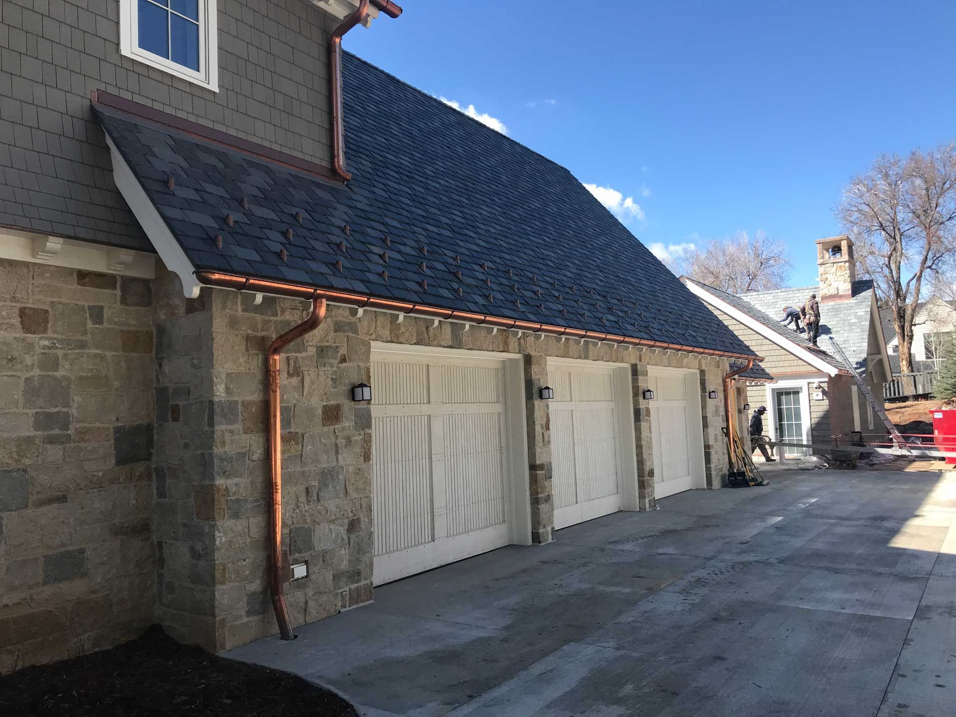 A large brick house with a driveway leading to it