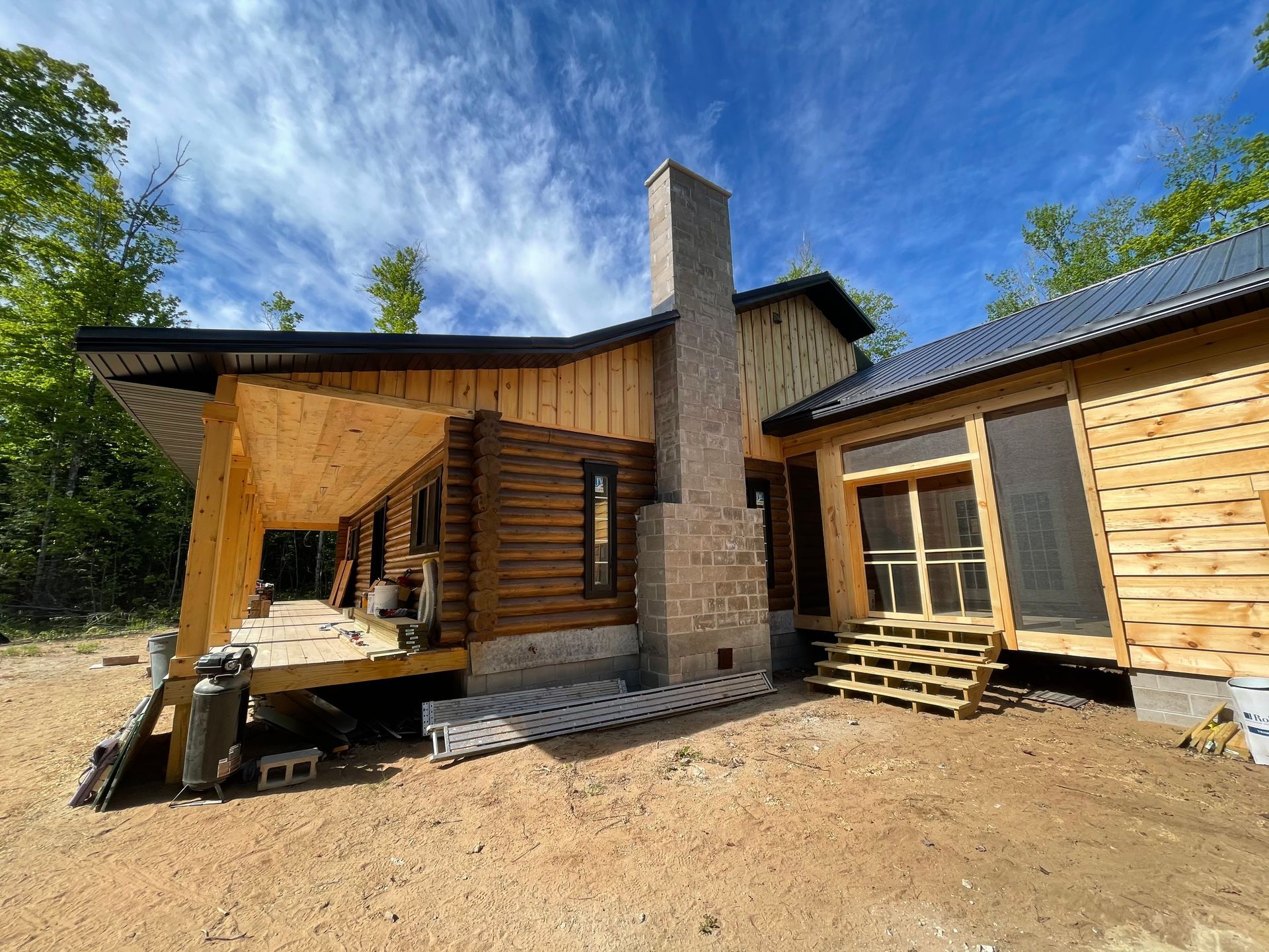 A log cabin is being built in the middle of a forest.