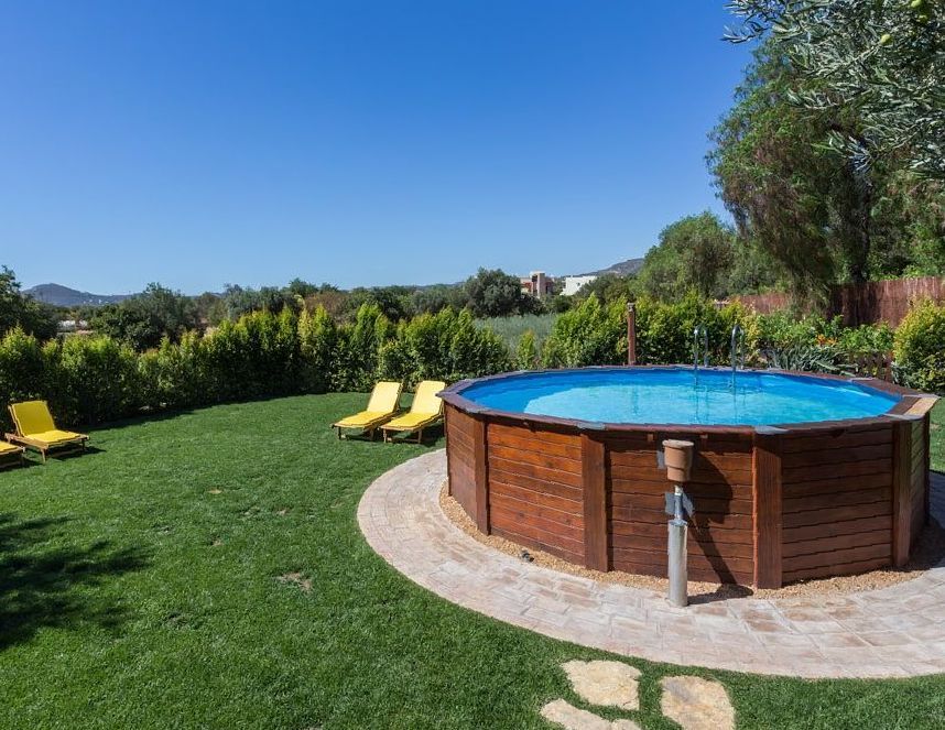 A Large Wooden Swimming Pool Is Sitting On Top Of A Lush Green Lawn — Holiday Coast Pools & Water In Coffs Harbour, NSW