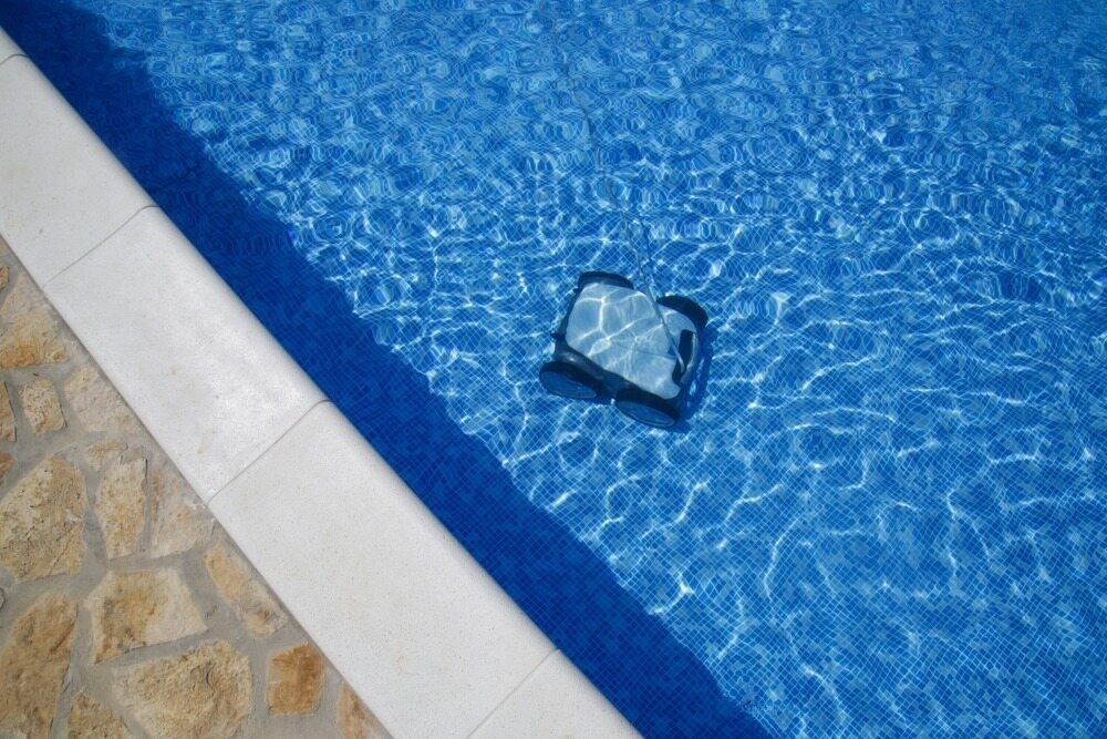 A Pool Cleaning Machine In A Swimming Pool — Holiday Coast Pools & Water In Urunga, NSW