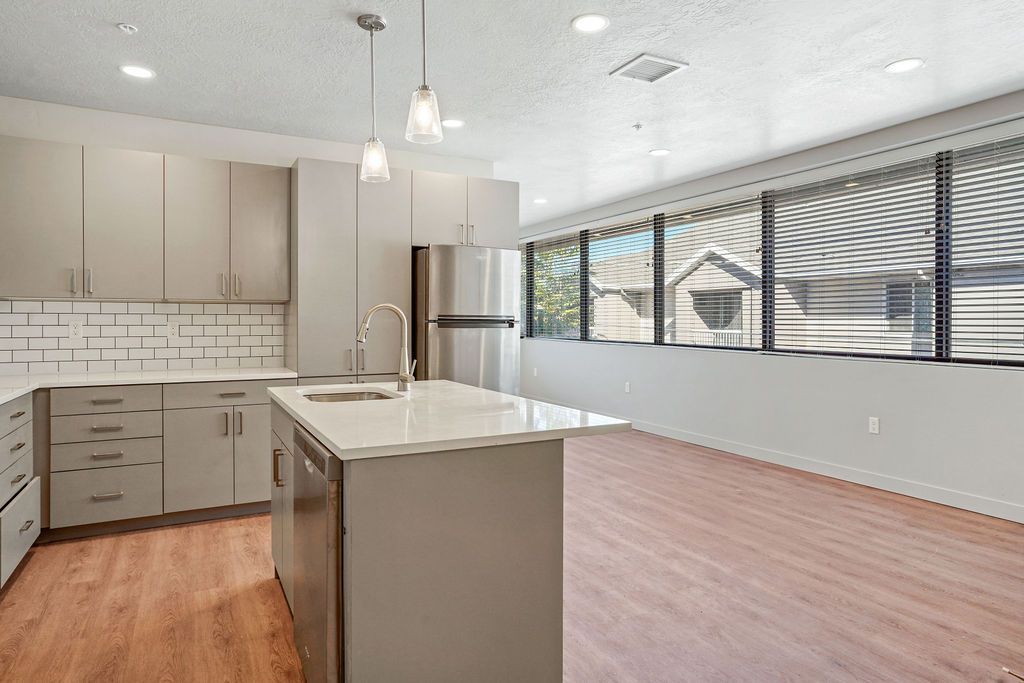 A kitchen with a large island in the middle of the room.