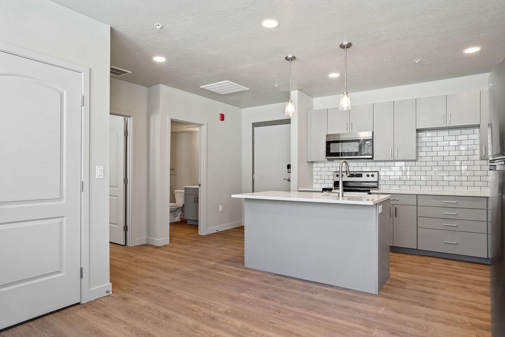 There is a large island in the middle of the kitchen.