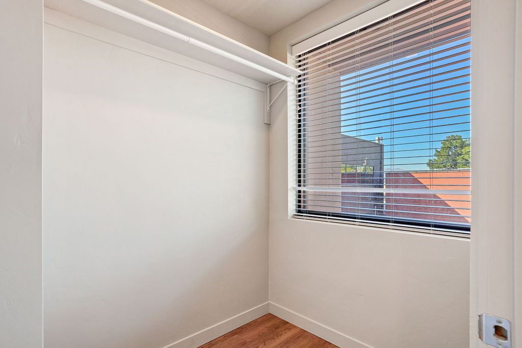 An empty room with a window and blinds on it.