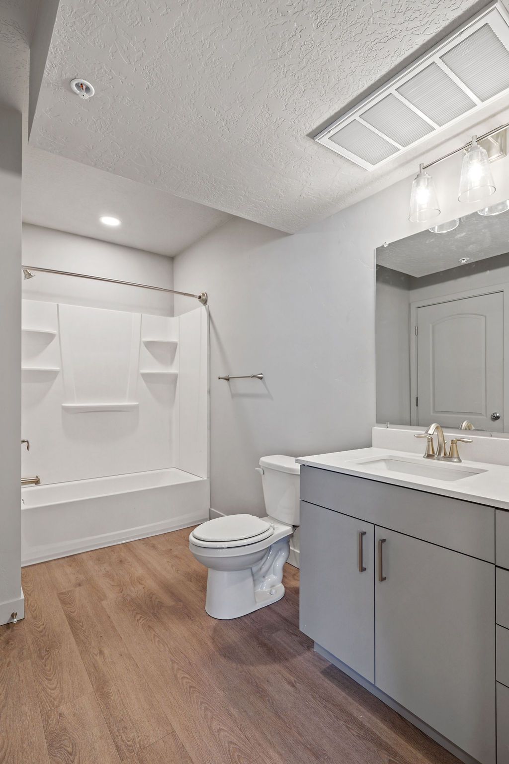 A bathroom with a toilet , sink , and bathtub.