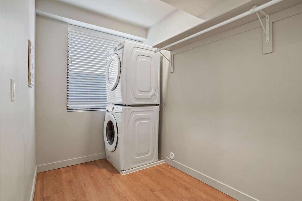 A laundry room with a washer and dryer stacked on top of each other.