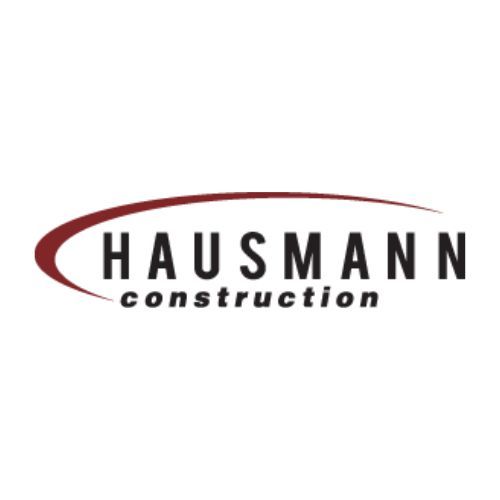 a logo for hausmann construction on a white background