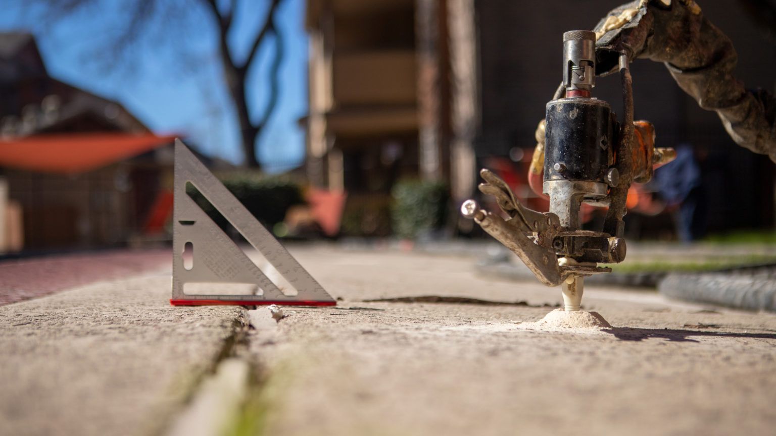 A close up of a person using a machine on a sidewalk.