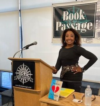 Diane author, stands at a podium in front of a sign that says book passage