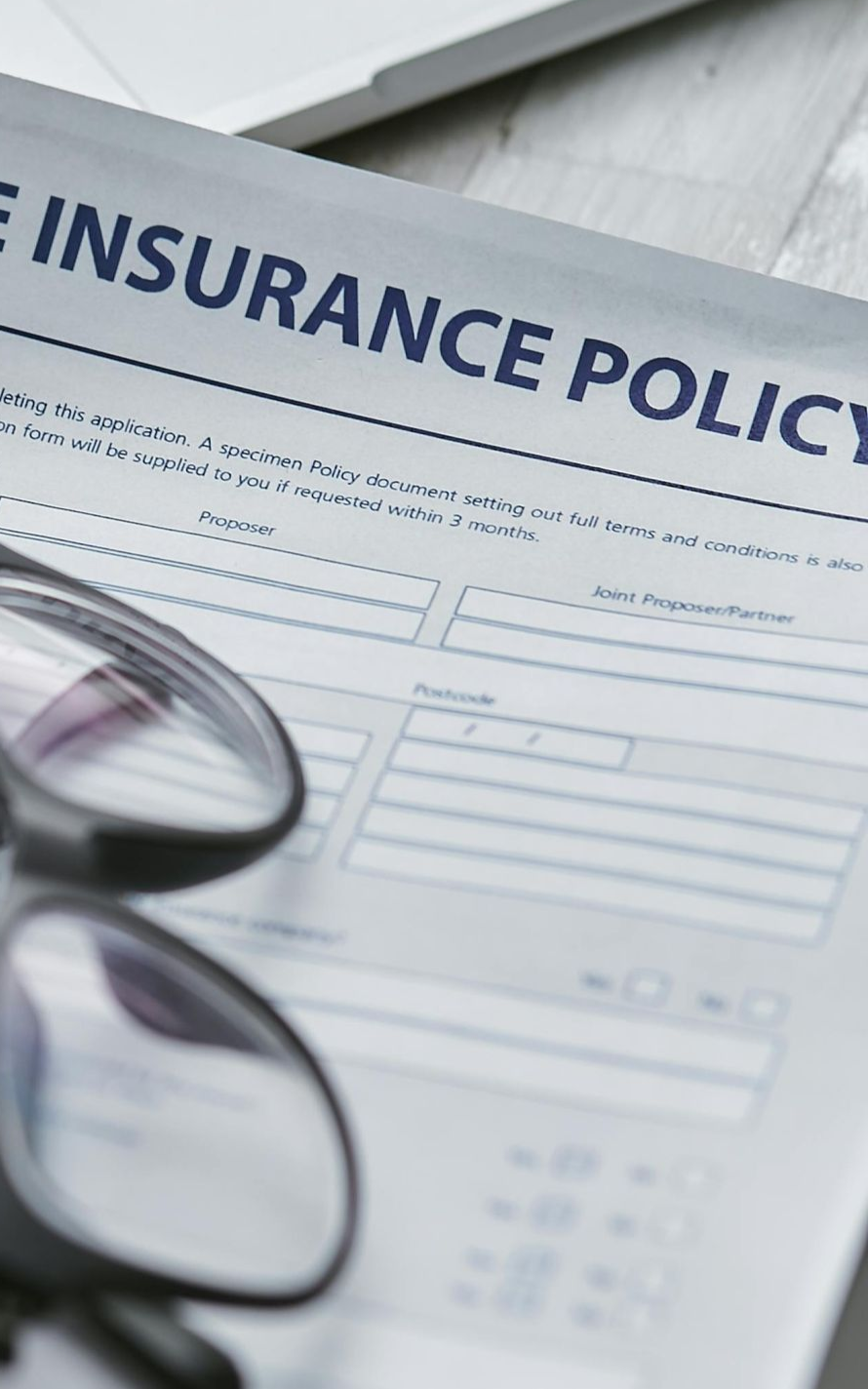 Life insurance policy with eyeglasses.