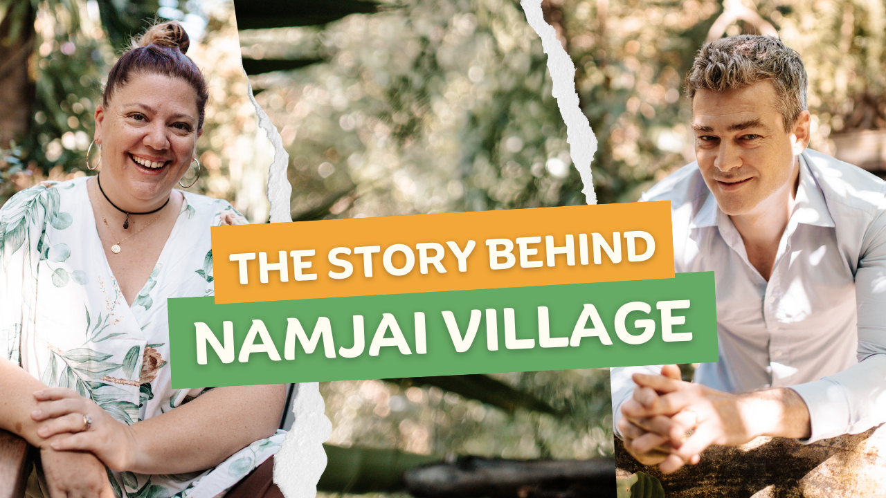 A man and a woman are sitting next to each other with a banner that says the story behind namjai village