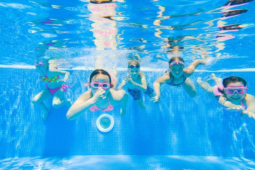 A Group Of Children Are Swimming Underwater In A Swimming Pool — Splash-A-Bout Swim School Pty Ltd In Glenden, QLD