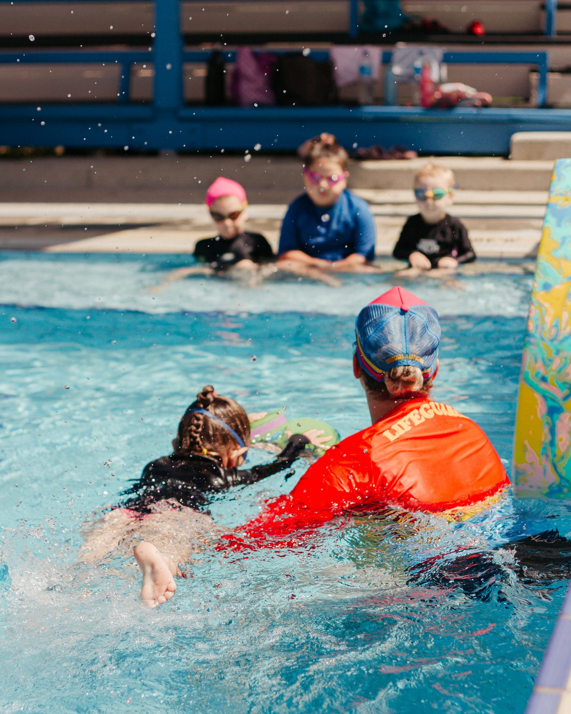 A Group Of Children Are Swimming In A Pool With A Lifeguard — Splash-A-Bout Swim School Pty Ltd In Park Avenue, QLD