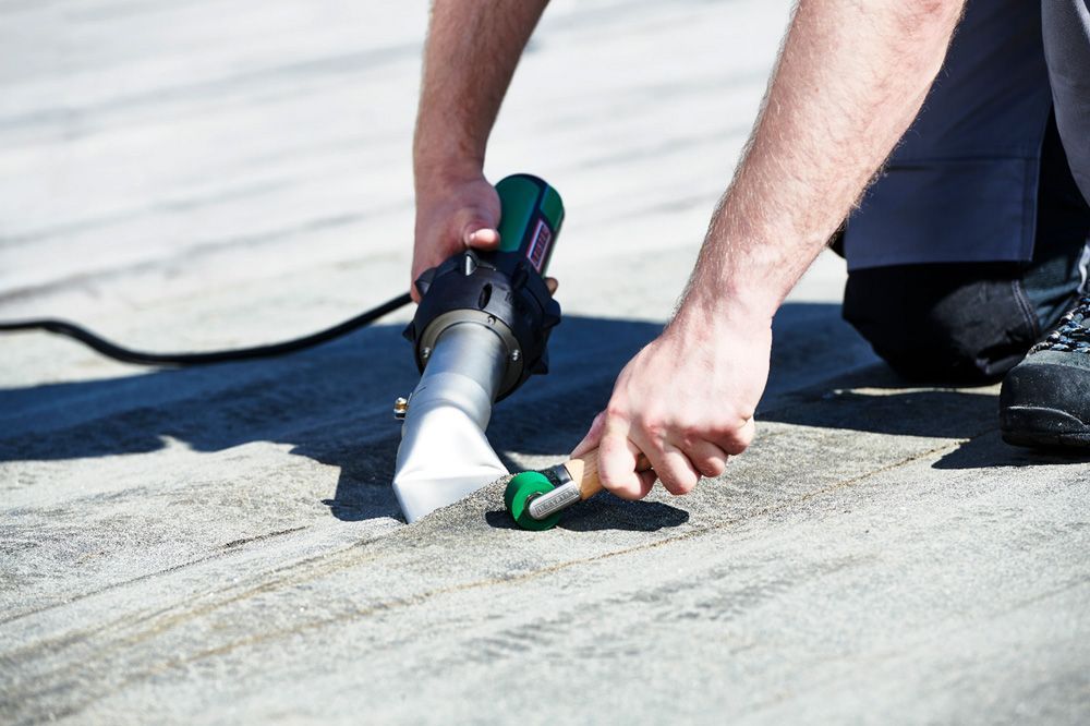 A person is using a tool on a concrete surface.