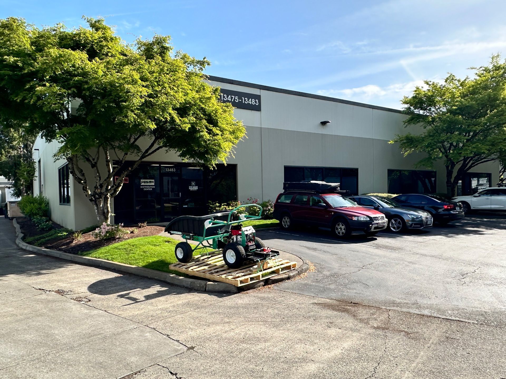 A lawn mower is parked in front of a building.