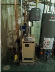 Boiler Heating Systems  — Man Fixing Water Heater in Battle Creek, MI