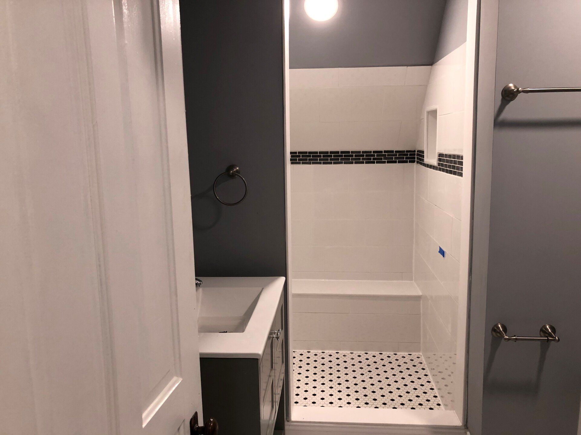 A bathroom with a shower , sink , and toilet.