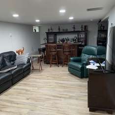 A living room filled with furniture and a bar.
