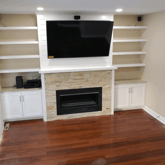 A living room with a fireplace and a flat screen tv