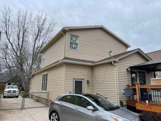 A car is parked in front of a house.