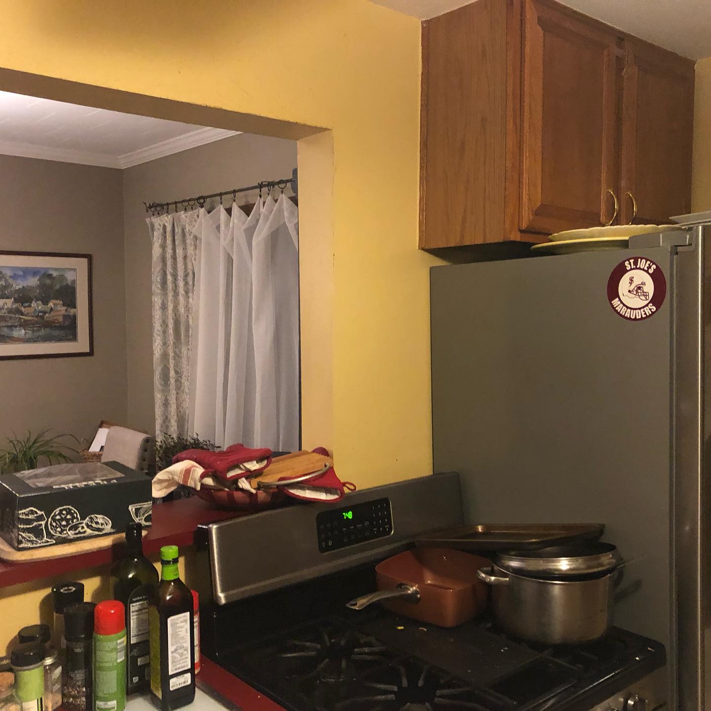 A kitchen with a stove top oven and a refrigerator with a sticker on it that says 