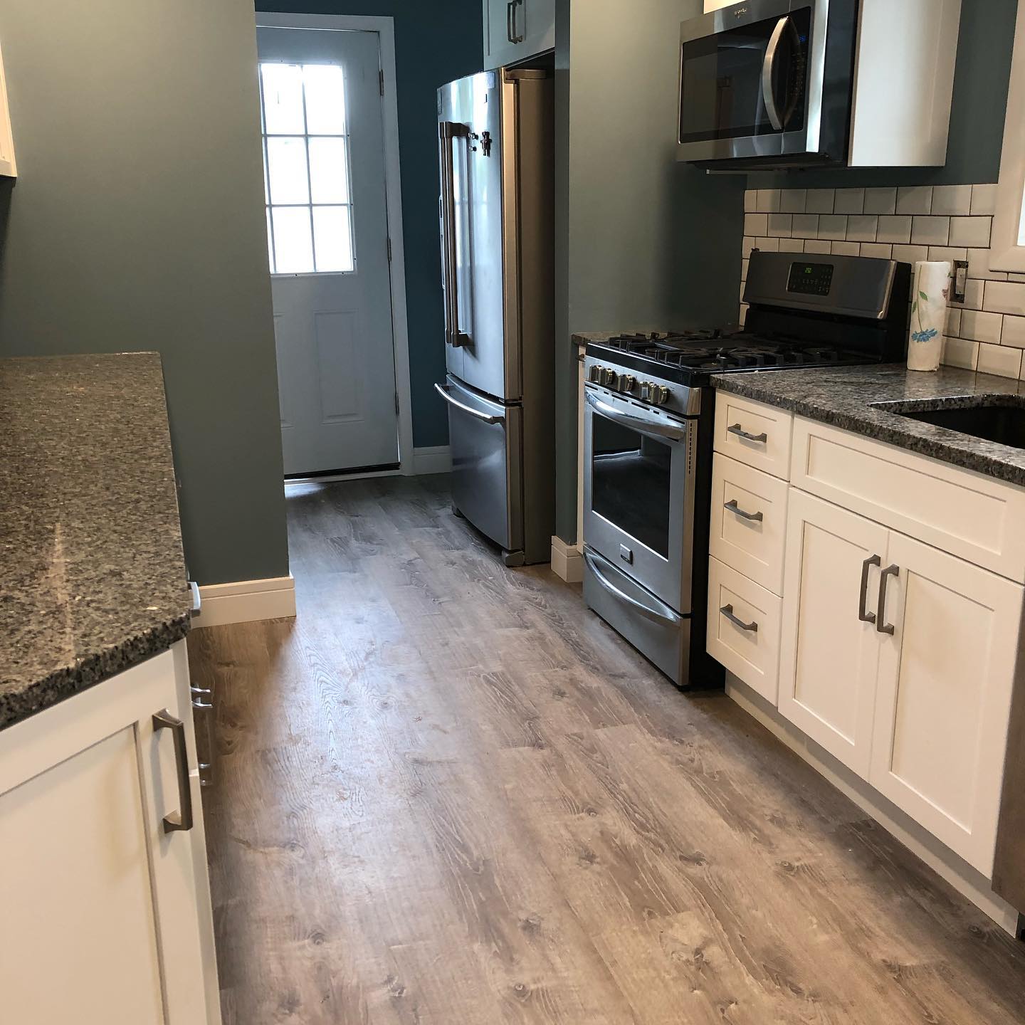 A kitchen with stainless steel appliances and granite counter tops