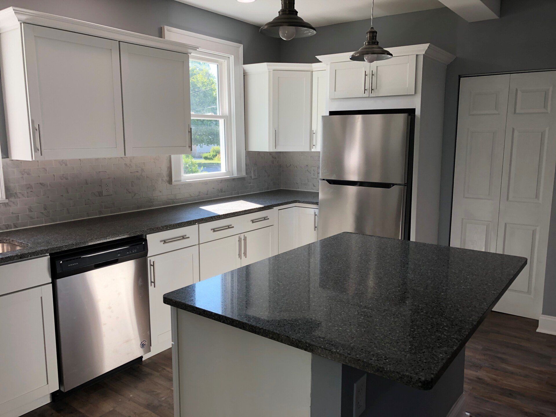 A kitchen with stainless steel appliances and granite counter tops