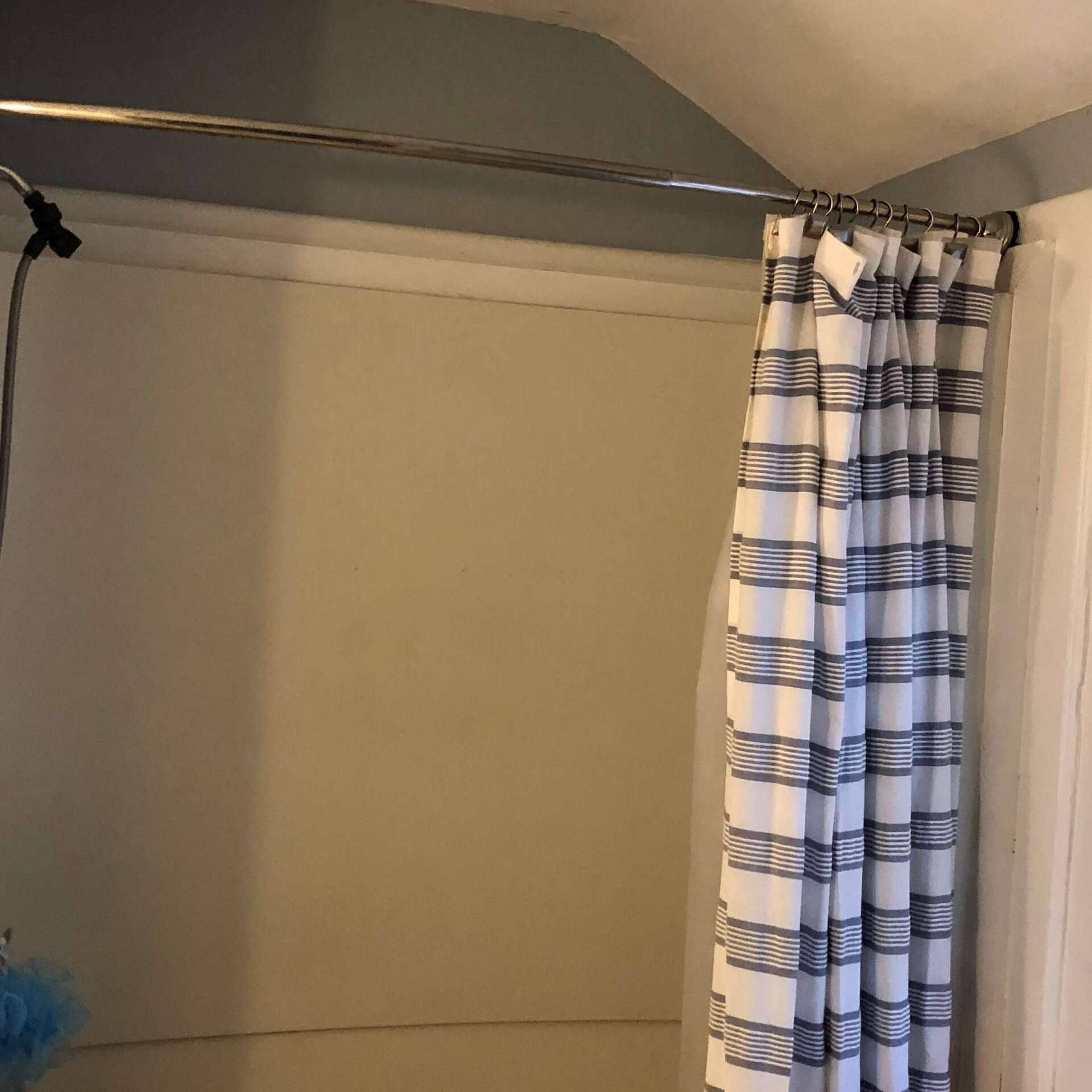 A shower curtain in a bathroom with a striped pattern