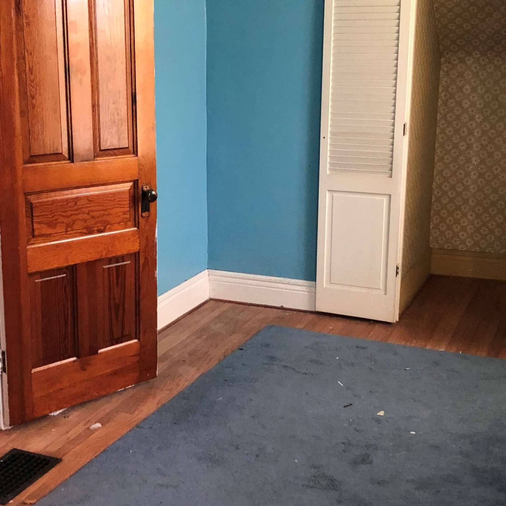 A room with blue walls and a wooden door