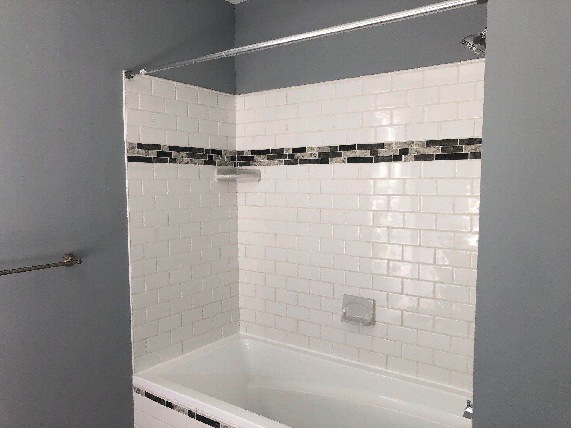 A bathroom with a bathtub and a shower.