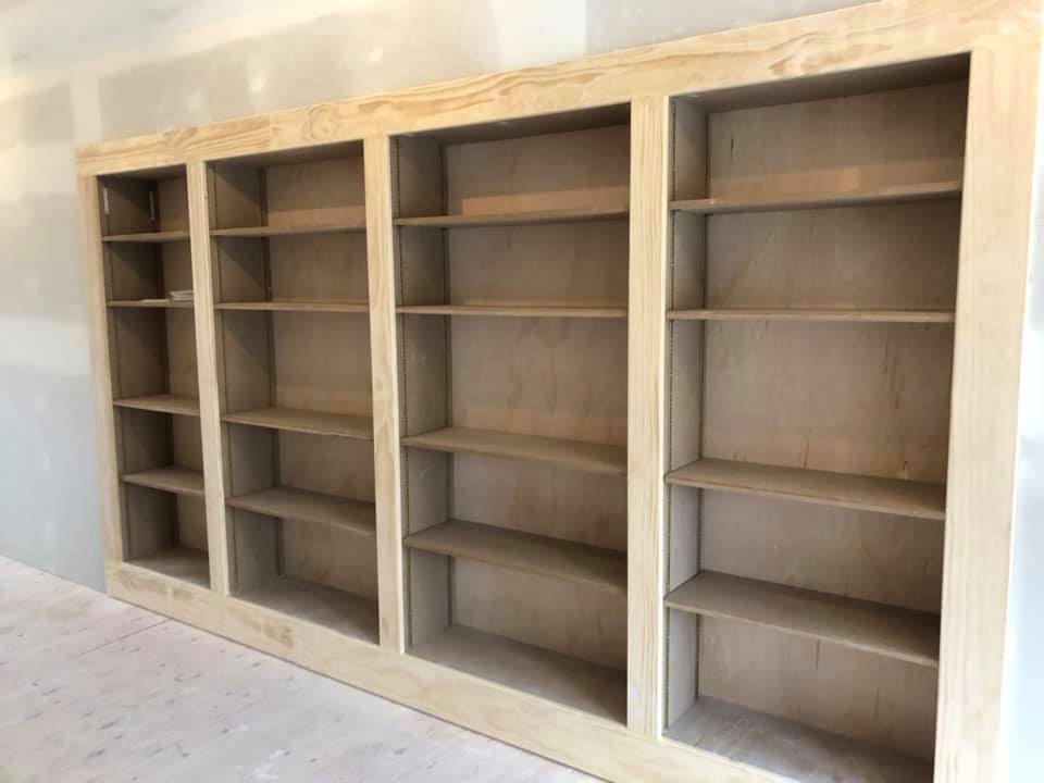 A row of wooden shelves sitting next to each other in a room.