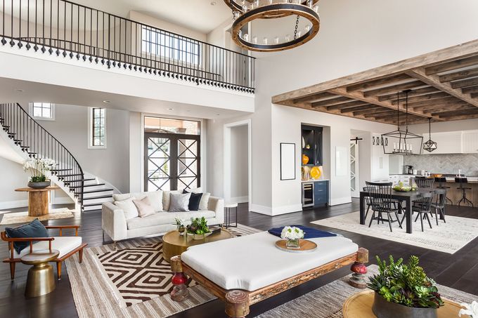 A living room filled with furniture and a staircase leading to the second floor.