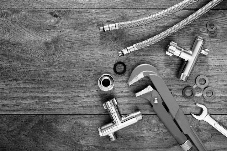 Set of plumbing tools on wooden table background