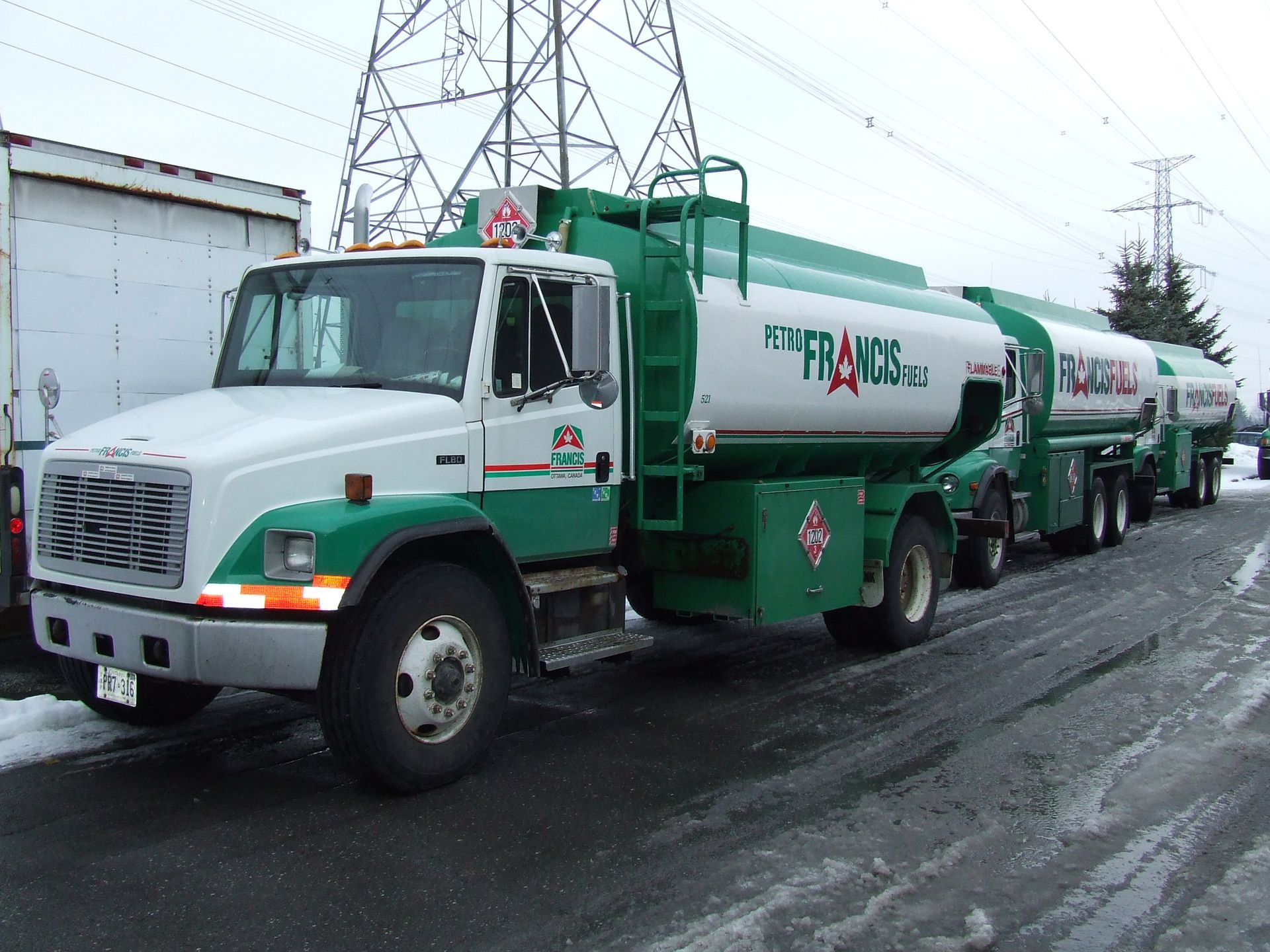 A green and white truck with the word francis on the side