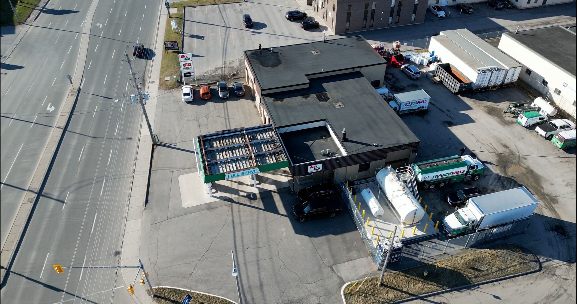 An aerial view of a building with a lot of trucks parked in front of it