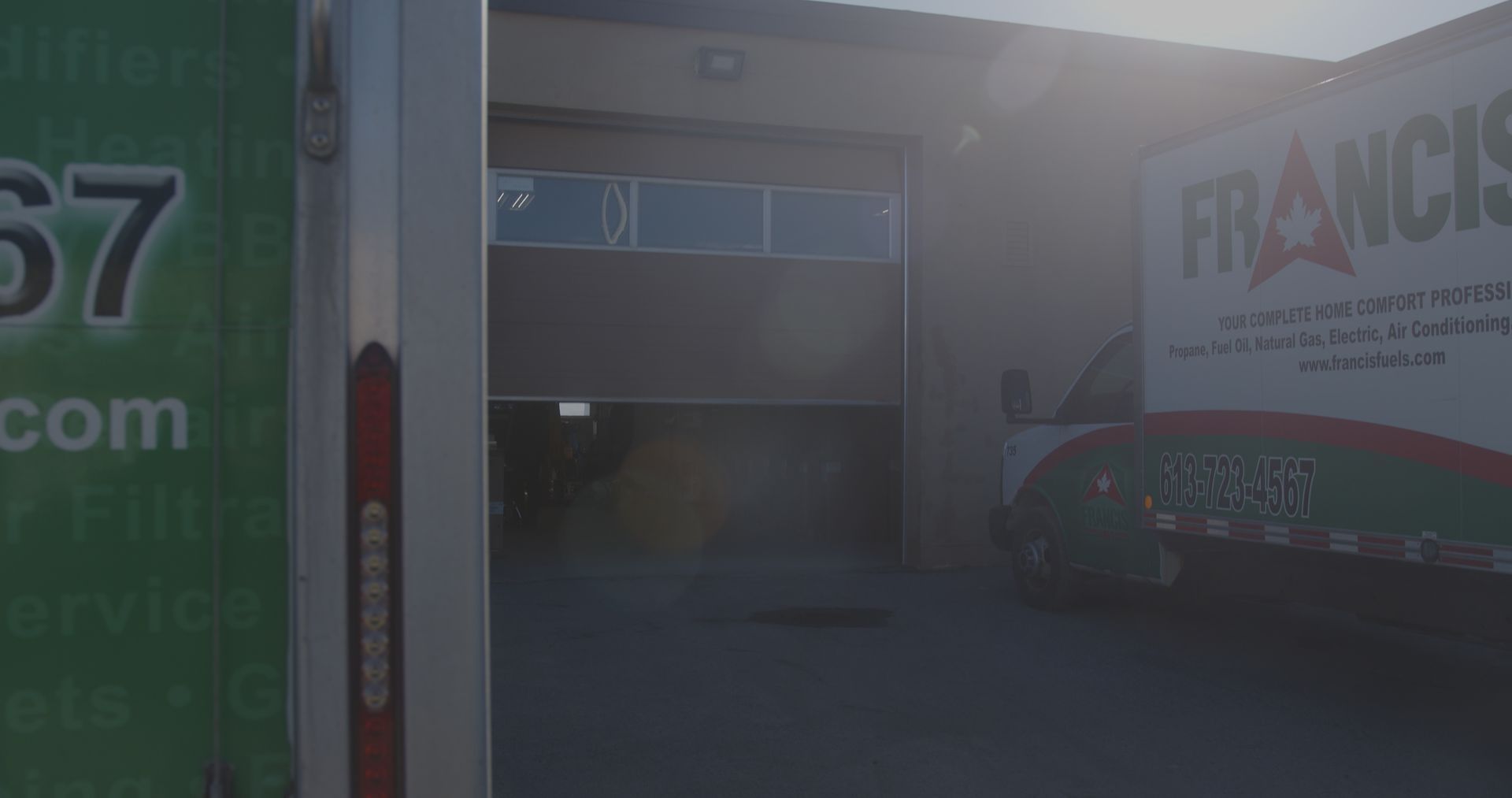 A white truck is parked in front of a building.