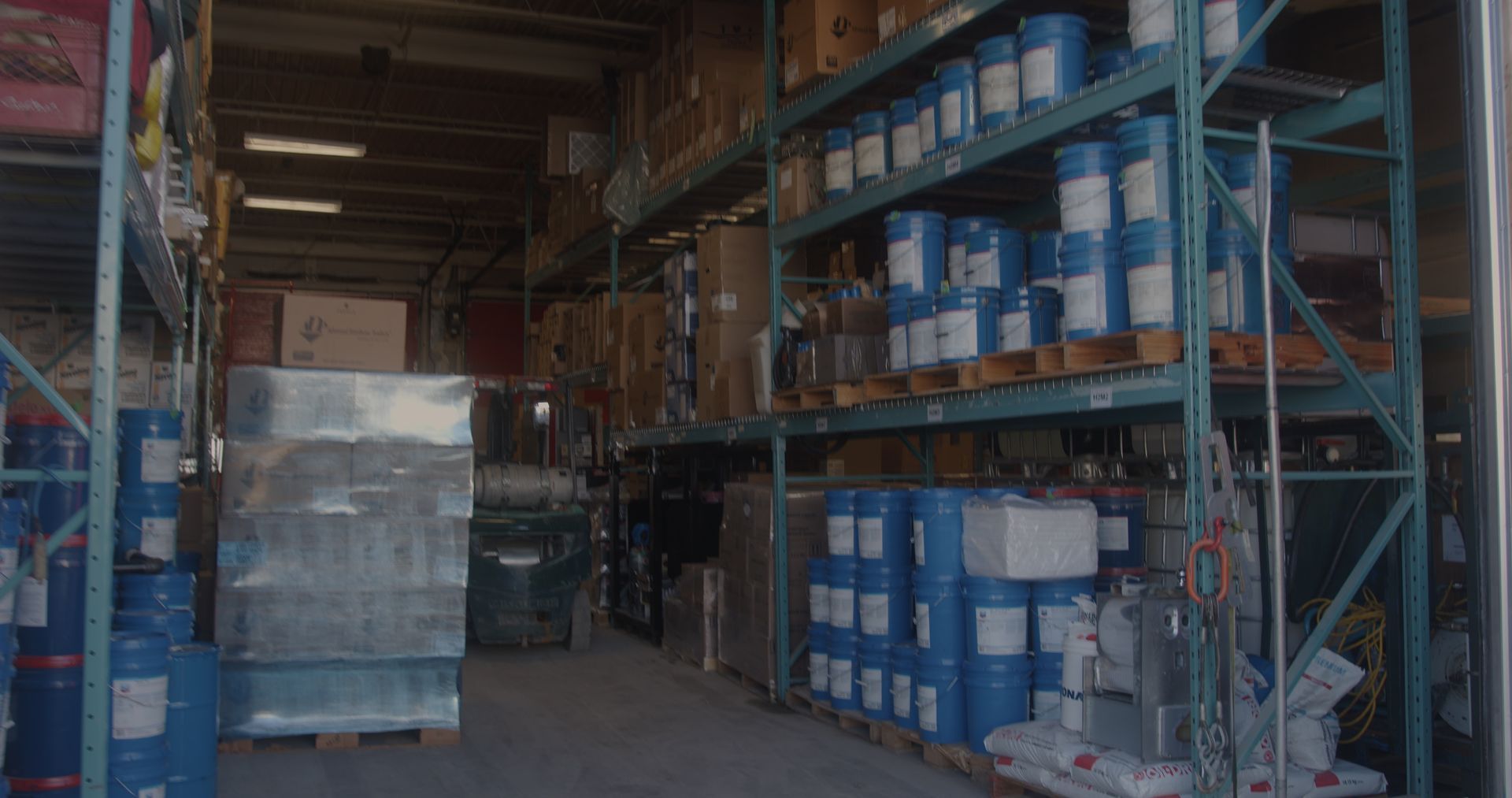 A large warehouse filled with lots of barrels and boxes.